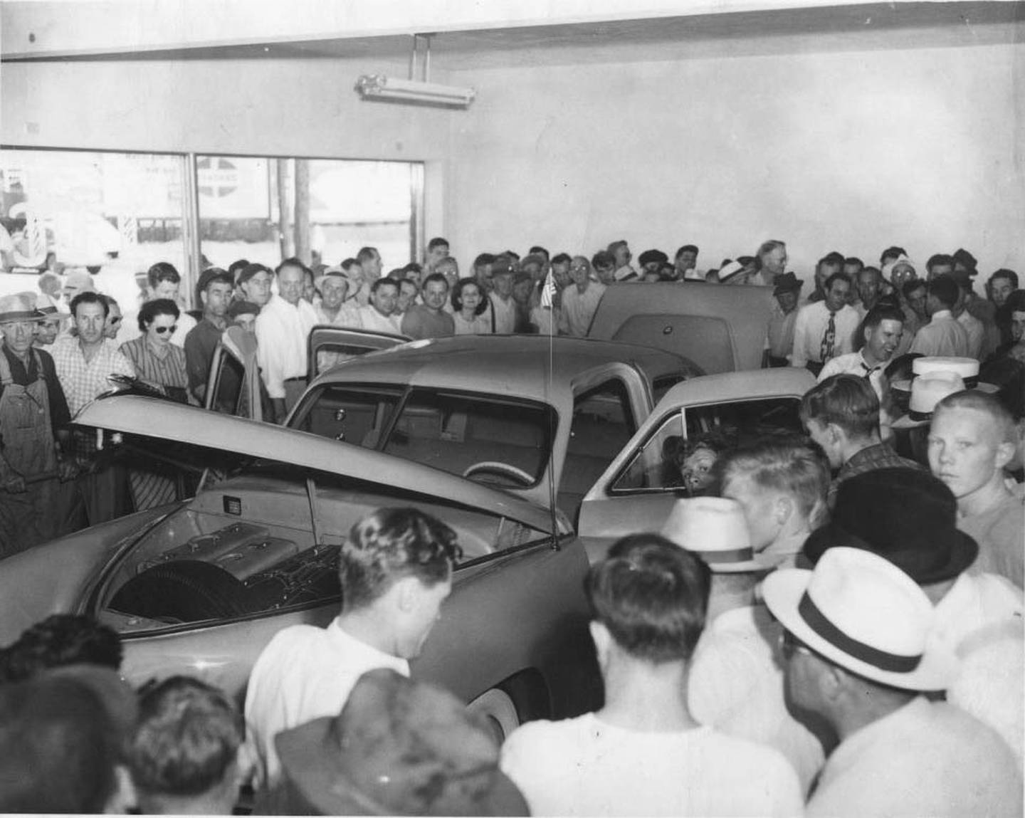 A crowd gathers to view the only Tucker automobile ever to be displayed in the Tucker dealership showroom in Ottawa in 1947.