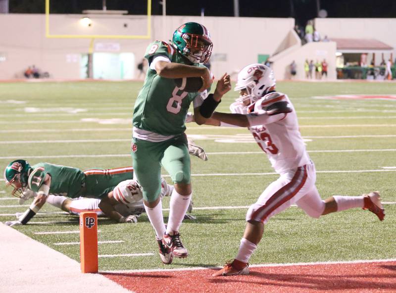 L-P quarterback Marion Persich eyes the end zone as Ottawa's Diego Martinez arrives late to the play on Friday, Sept. 13, 2024 at Howard Fellows Stadium.