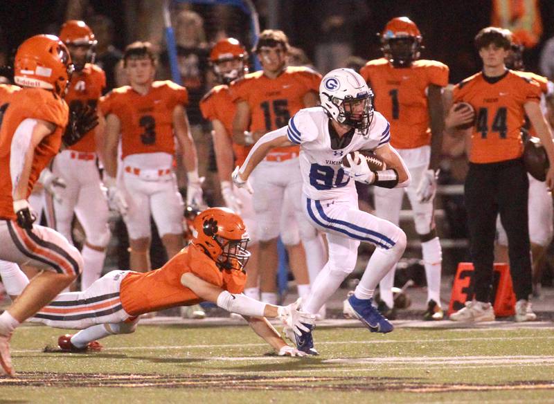 Geneva’s Bennett Konkey (right) escapes the grasp of Wheaton Warrenville South’s Colin Cahill during a game Friday, Sept. 13, 2024 in Wheaton.