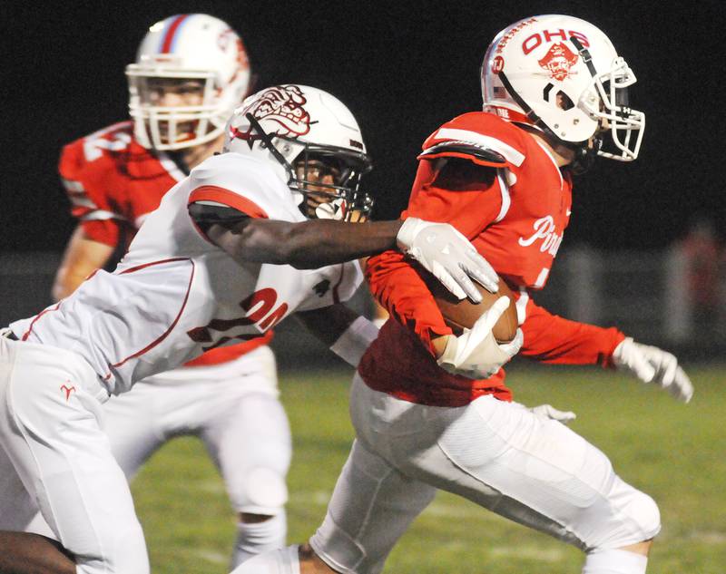 Streator's Jeremiah Brown (22) tries to strip the ball from Ottawa ballcarrier Levi Sheehan during the 2021 rivals' meeting at King Field in Ottawa.