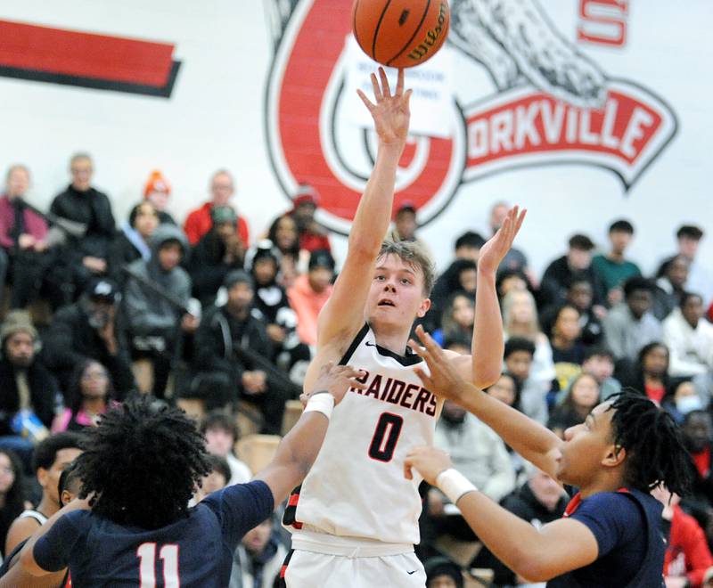 Bolingbrook's Trey Brost (0) takes a shot between two West Aurora defenders during a class 4A regional championship basketball game at Yorkville High School on Friday, Feb. 23, 2024.