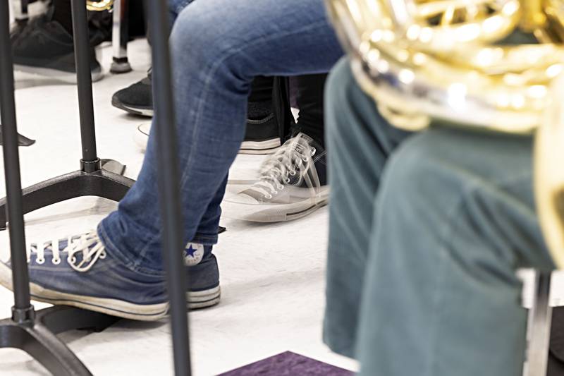 A Dixon High School band student taps their foot to keep the time during practice Tuesday, April 11, 2023.