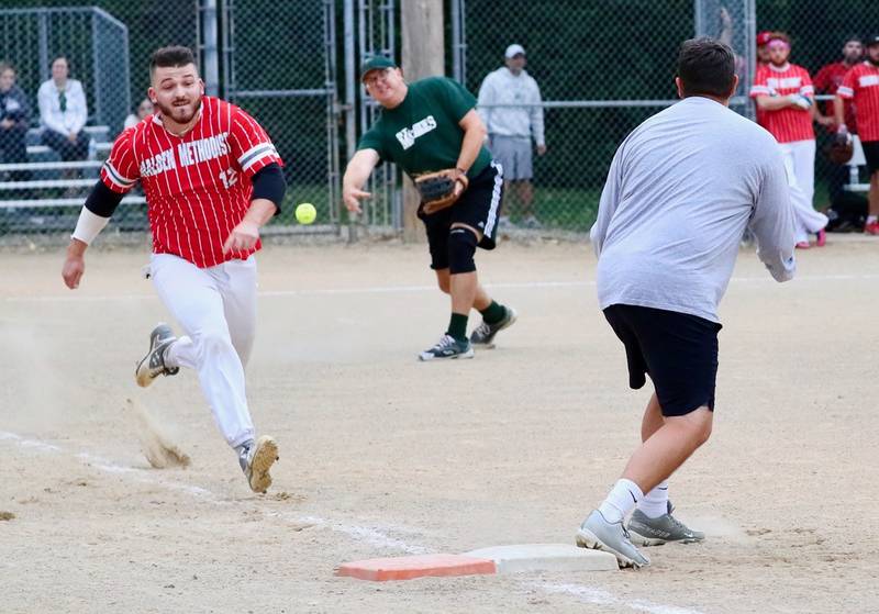 St. Mathews pitcher Chris Waca fires to first baseman Blair Bickett to try to throw out Tanner Kuhne of Malden Methodist in Tuesday's Princeton Park District Fastpitch tournament championship action.