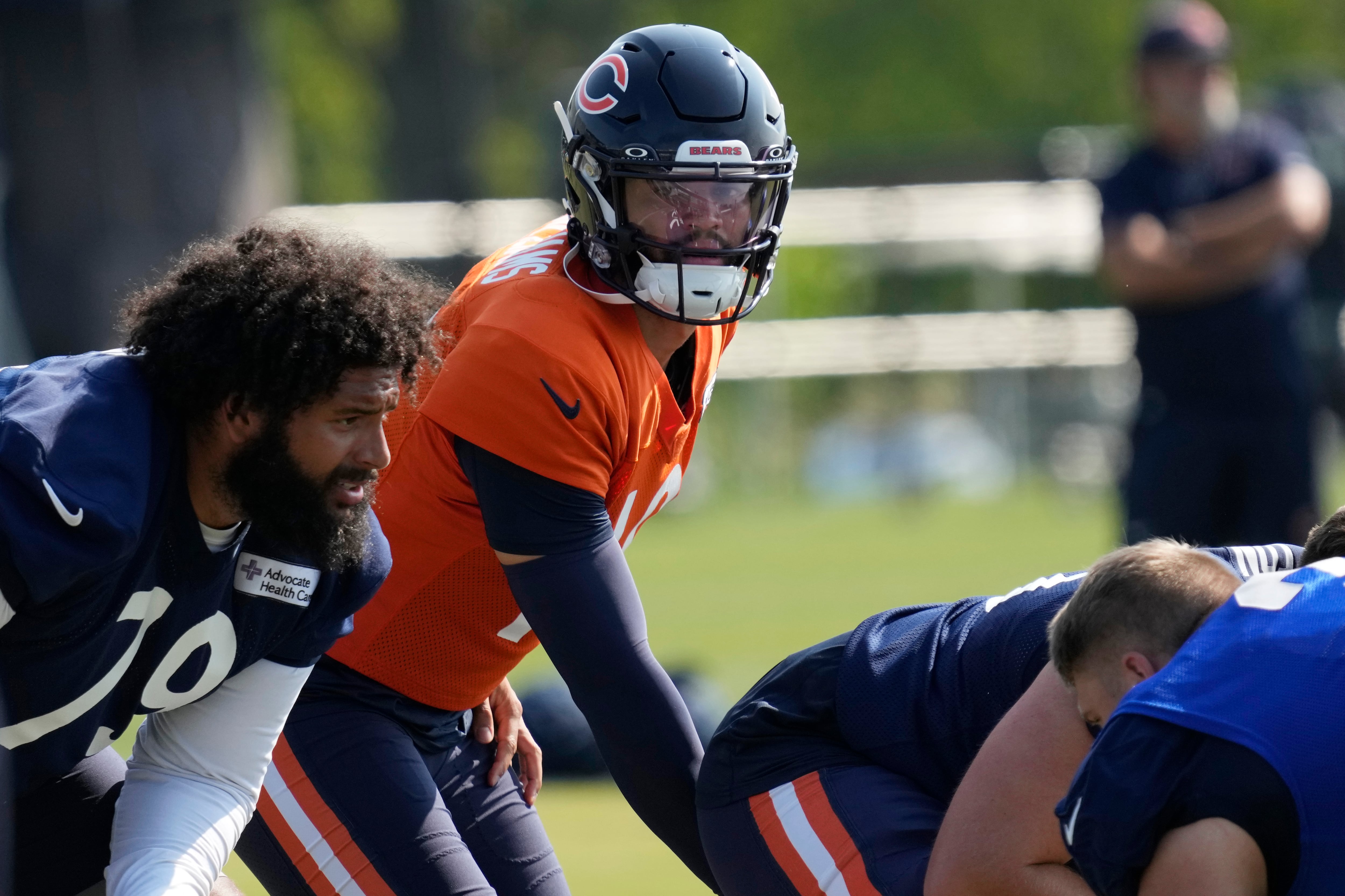 Chicago Bears quarterback Caleb Williams, center, works with teammates during an NFL football training camp practice in Lake Forest, Ill., Saturday, July 27, 2024. (AP Photo/Nam Y. Huh)