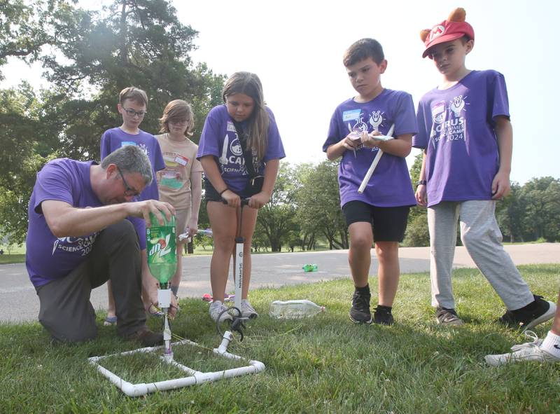 Dan Fitzpatrick camp instructor, teaches students how to launch a two liter rocket bottle with water during the 22nd annual Carus Summer Science Camp on Friday, July 12, 2024 at St. Bede Academy.