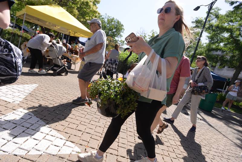 People including Lindsay Brauneis of Lagrange Park buys items at the LaGrange Farmers Market Thursday June 7, 2024.