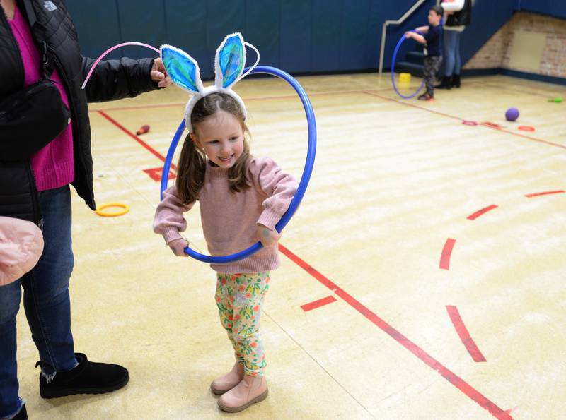 Children including Jackie Spagnola of Downers Grove play various games in the Downers Grove Community Center gym during the Downers Grove Bunny Hop Egg Hunt Friday, March 22, 2024.