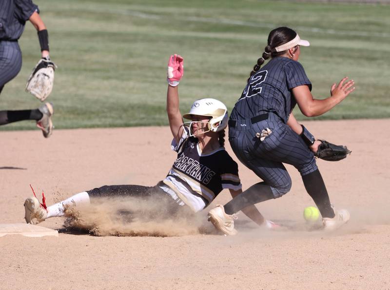 Sycamore's Faith Heil slides in with a stolen base as Kaneland's Angelina Campise can’t corral the throw during their Class 3A sectional semifinal Thursday, May 30, 2024, at Sycamore High School.