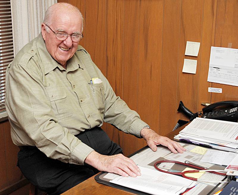 Dr. Ed Fesco sits at his desk in 2015.