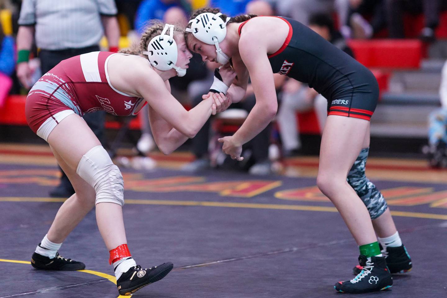 Lockport’s Claudia Heeney (left) competes against Huntley’s Aubrie Rohrbacher during a 130 pound championship match in the Schaumburg Girls Wrestling Sectional at Schaumburg High School on Saturday, Feb 10, 2024.