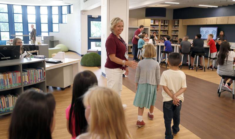 Social Worker Jenny Chromy leads a class through the renovated library learning center at Johnson Elementary School Wednesday August 16, 2023 in Warrenville.