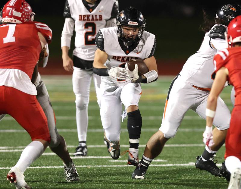 DeKalb's Talen Tate finds a hole in the Naperville Central defensive line during their game Friday, Oct. 6, 2023, at Naperville Central High School.