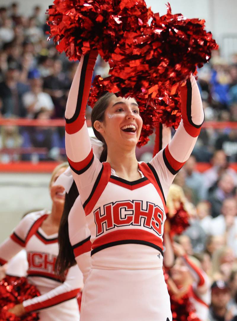 A Hinsdale Central cheerleader brings the crowd to its feet during the boys 4A varsity sectional semi-final game between Hinsdale Central and Lyons Township high schools in Hinsdale on Wednesday, March 1, 2023.