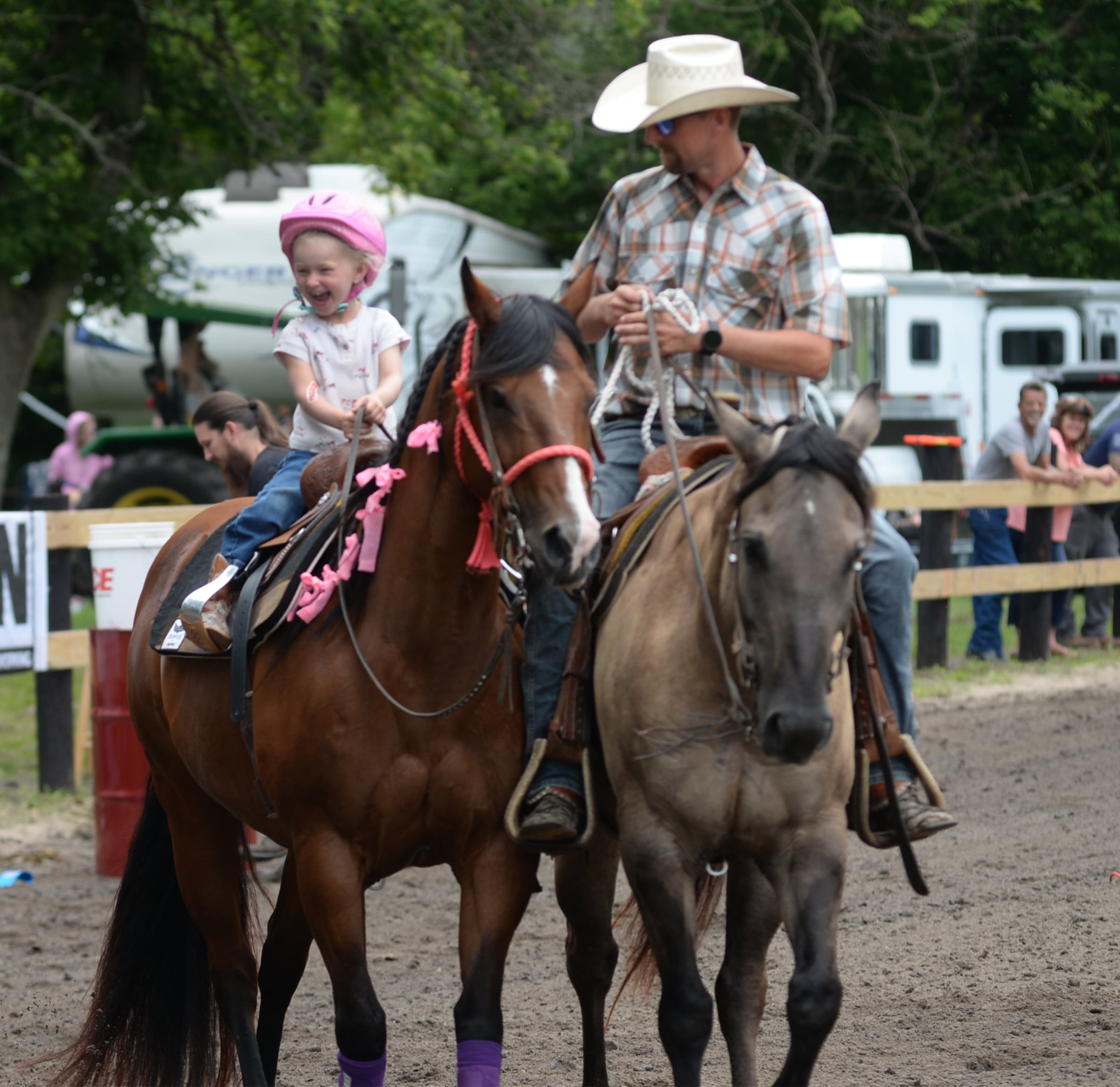 Savannah Chapman, 3, of Earlville, smiles at her mom as she rides her horse Sweet Pea, 20, with her dad Brad and his horse Hank, 6, at the end of their run in the Flags Competition at the Rock River Trail & Horseman Association's Grand Opening Show on Saturday, July 20, 2024.