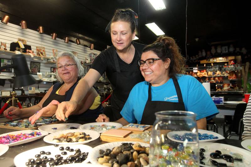 Ann Marie Robles, of Trevor, Wis., (center) owner and artist, helps Kim Menheer, of Round Lake Beach and Beth Cano, of Antioch make their own mosaic using stones, rocks and glass during a Mosaic class at Antioch Academy of Art & Museum on Tuesday, September 5th in Antioch.
Photo by Candace H. Johnson for Shaw Local News Network