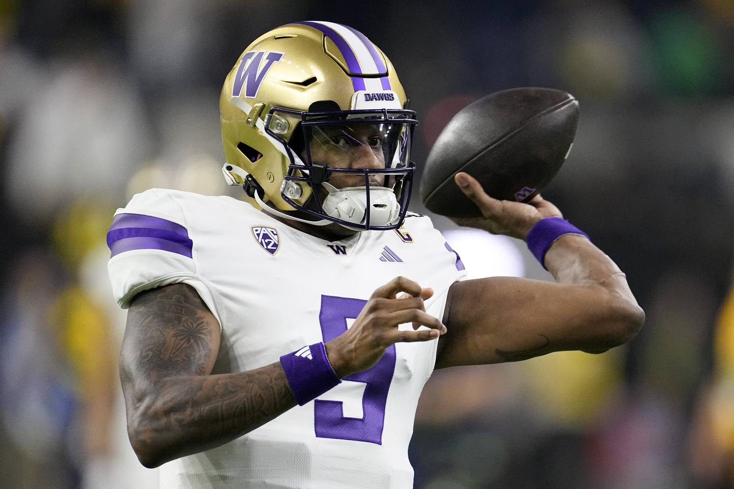 Washington quarterback Michael Penix Jr. warms up before the NCAA National Championship against Michigan on Monday, Jan. 8, 2024, in Houston.