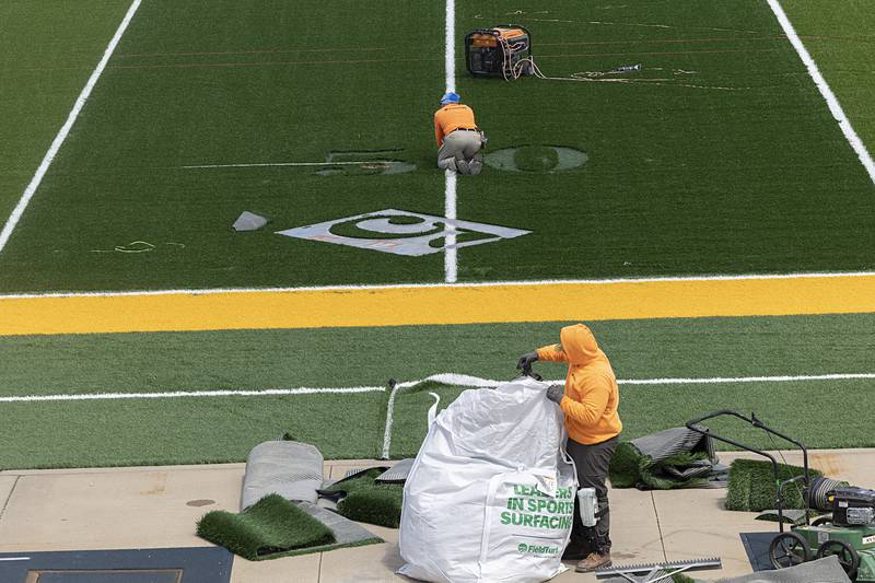 Turf workers get started on placing numbers on the field at Roscoe Eades stadium Thursday, June 6, 2024.