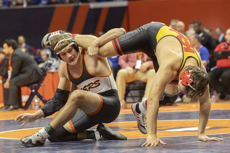 Crystal Lake South’s Cayden Parks grabs the leg of Rock Island’s Andrew Marquez face off in the 2A 190 pound championship match Saturday, Feb. 17, 2024 at the IHSA state wrestling finals at the State Farm Center in Champaign.