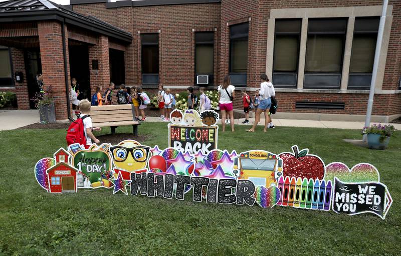 Students arrive for the first day of school at Whittier Elementary School in Downers Grove on Friday, Aug. 25, 2023.