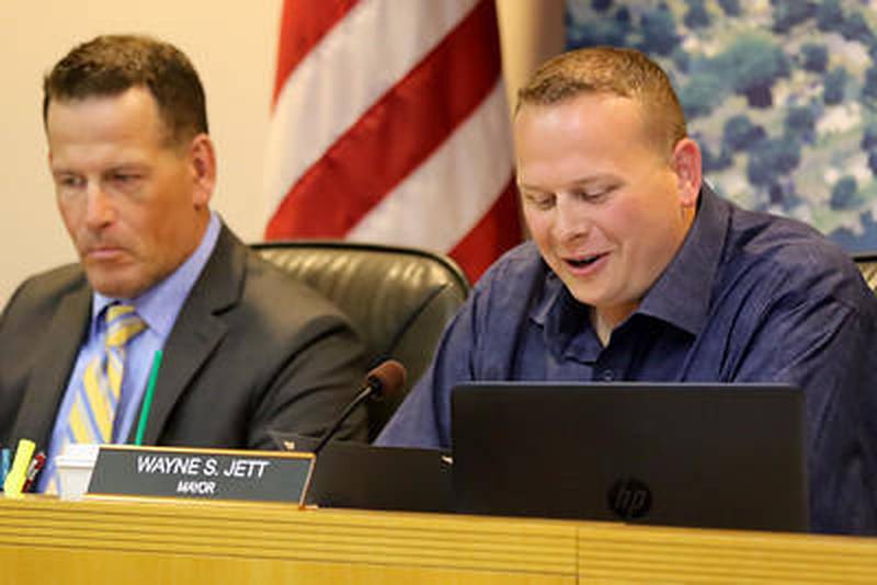 Derik Morefield (left) and Mayor Wayne Jett perform their duties during a McHenry City Council meeting on April 15 in McHenry.