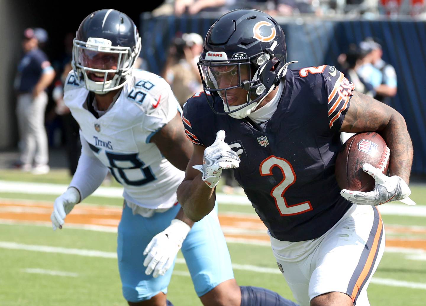 Chicago Bears wide receiver DJ Moore gets by Tennessee Titans linebacker Harold Landry III on a run play during their game Sunday, Sept. 8, 2024, at Soldier Field in Chicago.