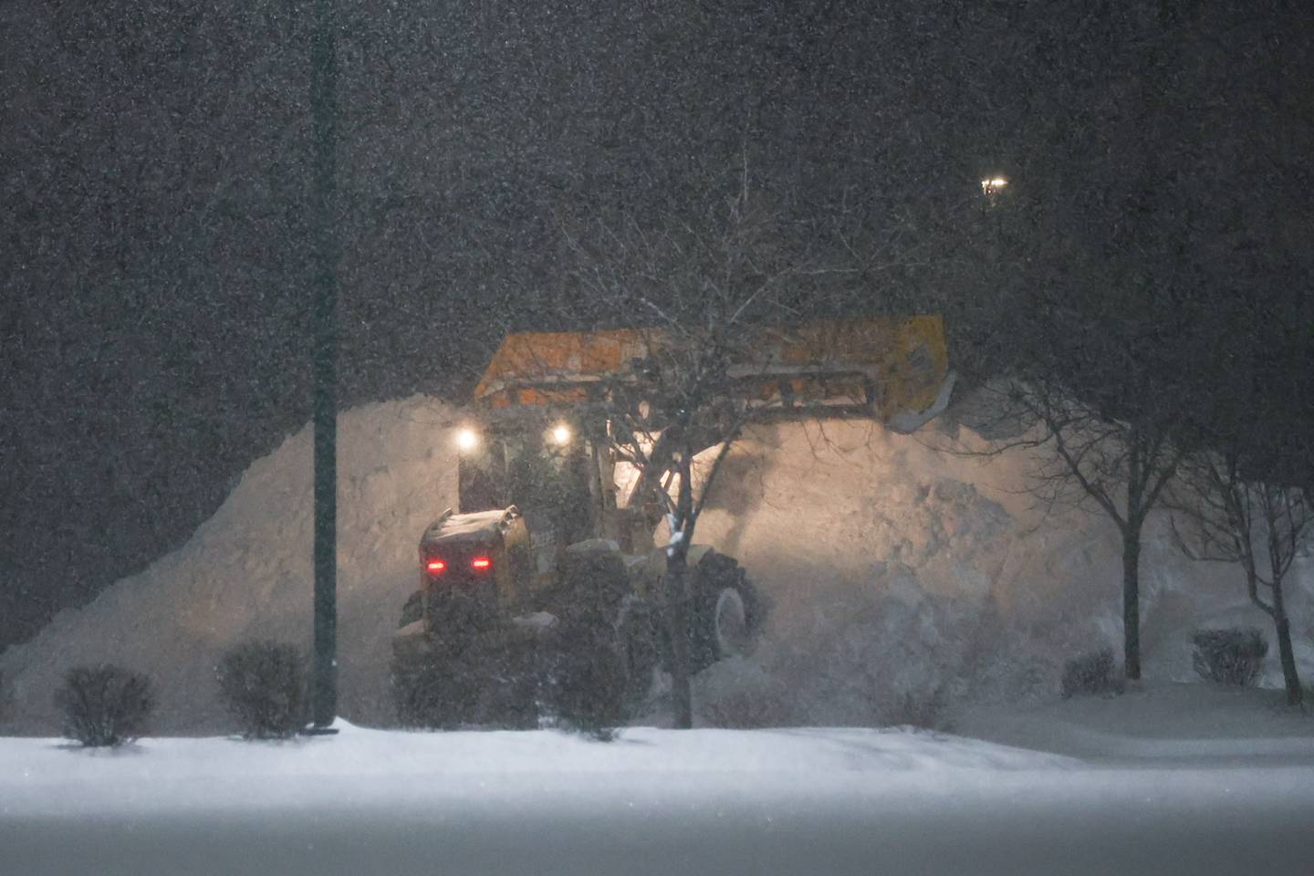 The mound of snow continues to grow as a snow removal company clears the parking lot of Menards before they open. Wednesday, Feb. 2, 2022, in Joliet.