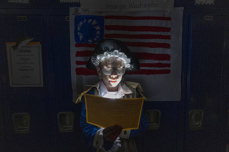 Austin Markey, third-grader at Washington School in Sterling, channels George Washington on Thursday, May 16, 2024, for his wax museum project at the school. Over 100 third-graders researched famous people, then lined the hallways and recited their knowledge for friends and family.