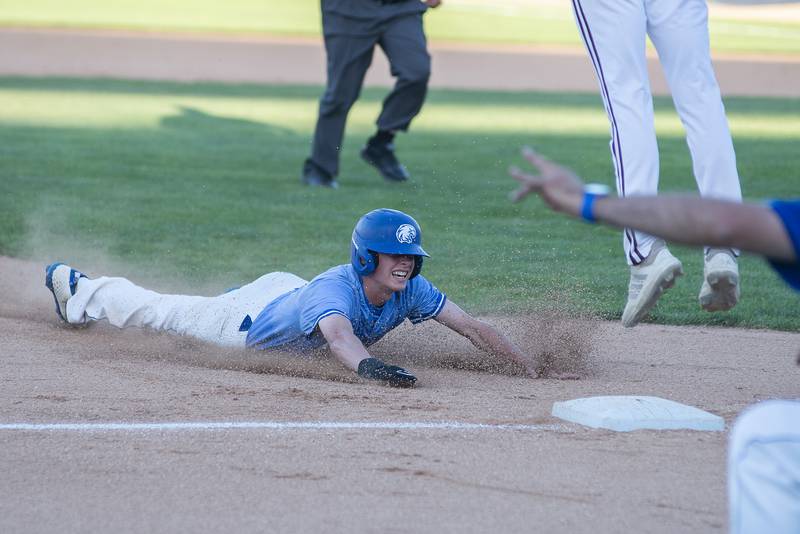 Columbia’s Jack Steckler slides in safely at third base against Joliet Catholic Friday, June 3, 2022 during the IHSA Class 2A baseball state semifinal.