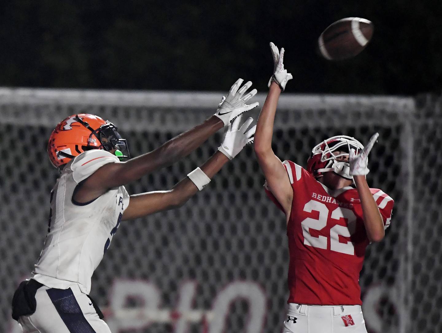 Naperville Central’s Nathan Monken breaks up a pass for Naperville North’s Luke Williams in a high school football game at North Central College in Naperville on Friday, September 29, 2023.