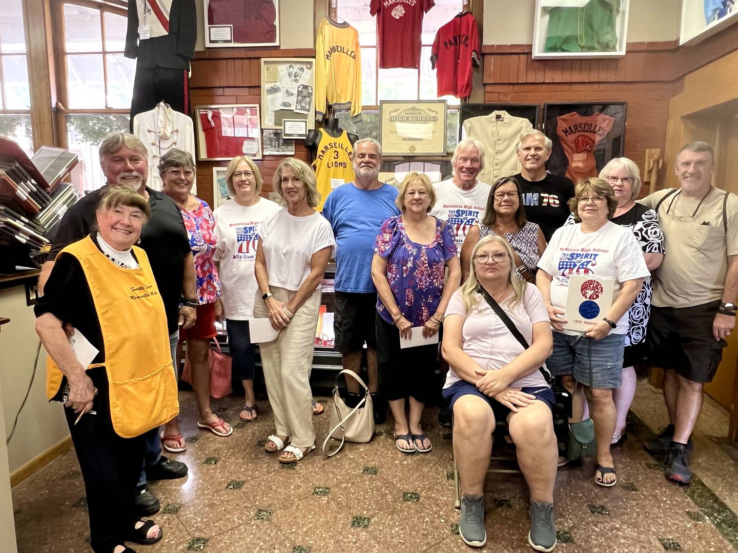 Marseilles High School classmates of 1976 visit with Seattle Sutton at the Seattle Sutton Marseilles Museum. They are (back, from left) Tammy (Taylor) Fleming, Kathy (Foster) Caputo, Don Sarles, Al Linton, Tim Hovious, Shelia
(Byrd) Terry, Steve Farrell; (front, from left)
Craig Emmett, Laura (CliRord) Fritz, Janet (Maskel) Meyer, Cheryl (Fenoglio) Ringer, Donna (Fisher) Wise, (seated) Gail (Galloway) Plique.