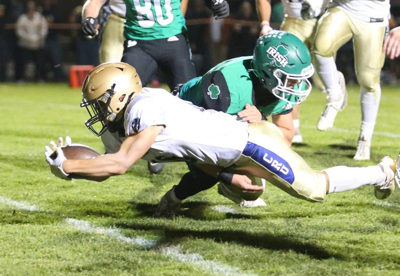 Marquette's Payton Gutierrez dives for the end zone to score a touchdown as Seneca's Nick Grant tackles him late on Friday, Oct. 18, 2024 at Seneca High School.