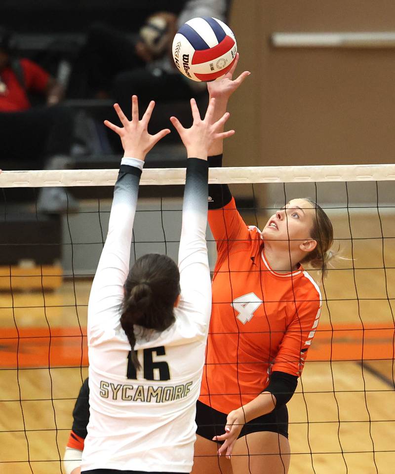 DeKalb's Maddi Hollar tries to get the ball past Sycamore's Norah Chami during their match Wednesday, Aug. 28, 2024, at DeKalb High School.