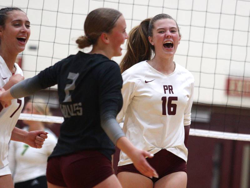 Prairie Ridge’s Adeline Grider, right, and the Wolves get revved up in their win over district rival Crystal Lake South in varsity girls volleyball on Thursday, Aug. 29, 2024, at Prairie Ridge High School in Crystal Lake.