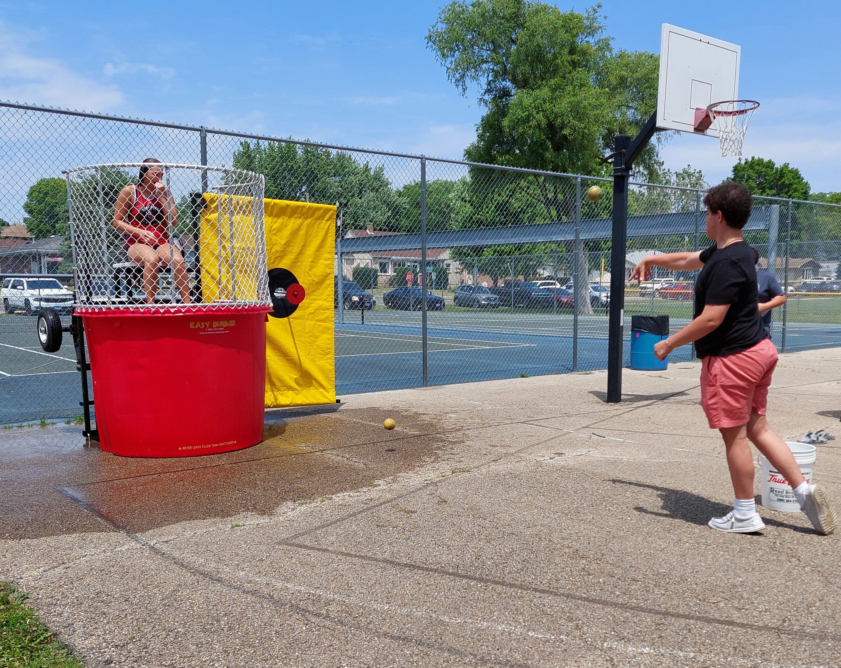 A Summerfest attendee takes a throw at the dunk tank Saturday, June 10, 2023, during the event at Kirby Park in Spring Valley.