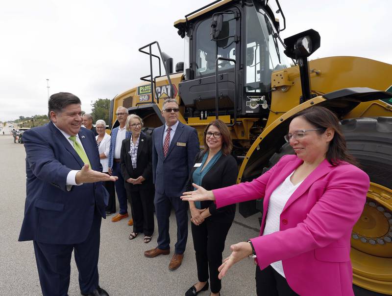 Illinois Gov. JB Pritzker greets State Sen. Cristina Castro and other dignitaries before the long awaited opening of Longmeadow Parkway over the Fox River Thursday, Aug. 29, 2024 in Algonquin.