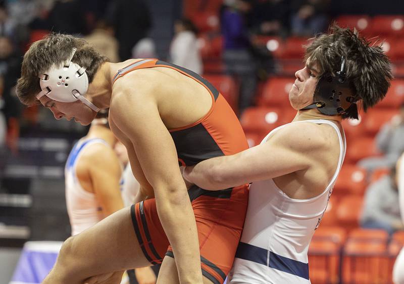 IC Catholic’s Foley Calcagno lifts Washington’s Josh Hoffer in the 190 pound third place 2A match Saturday, Feb. 17, 2024 at the IHSA state wrestling finals at the State Farm Center in Champaign.