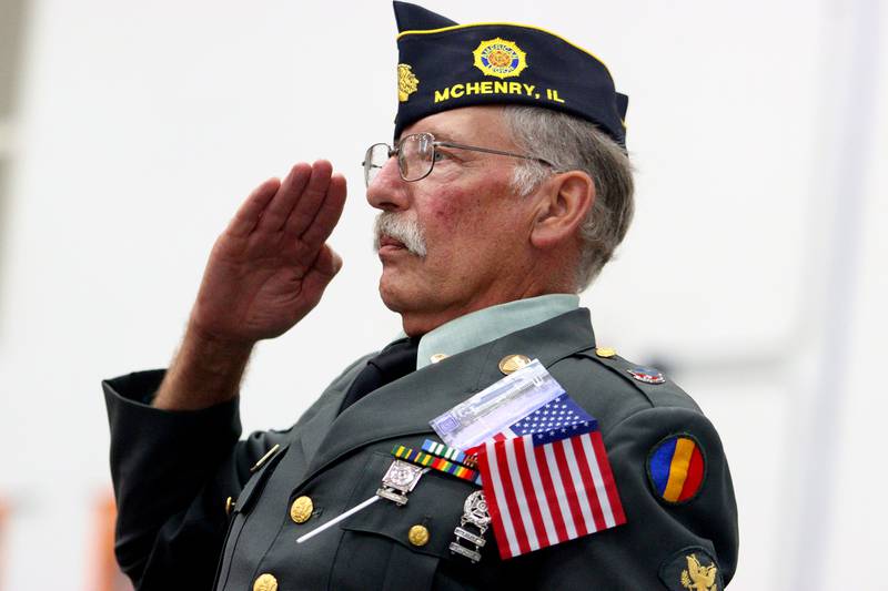 Carl Kamienski of Johnsburg salutes the flag as McHenry Community High School hosted a celebration Sunday for veterans returning from an Honor Flight trip to Washington D.C. The Honor Flight trip was coordinated by the Veterans Network Committee of Northern Illinois.