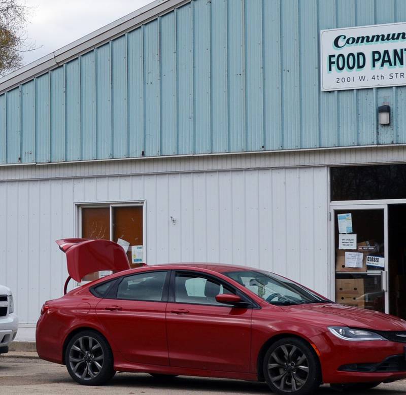 A line of cars waits outside the Dixon Community Food Pantry on Friday, Nov. 10, 2023. Guests wait in their vehicles while the items on their shopping lists are gathered and brought out to them.