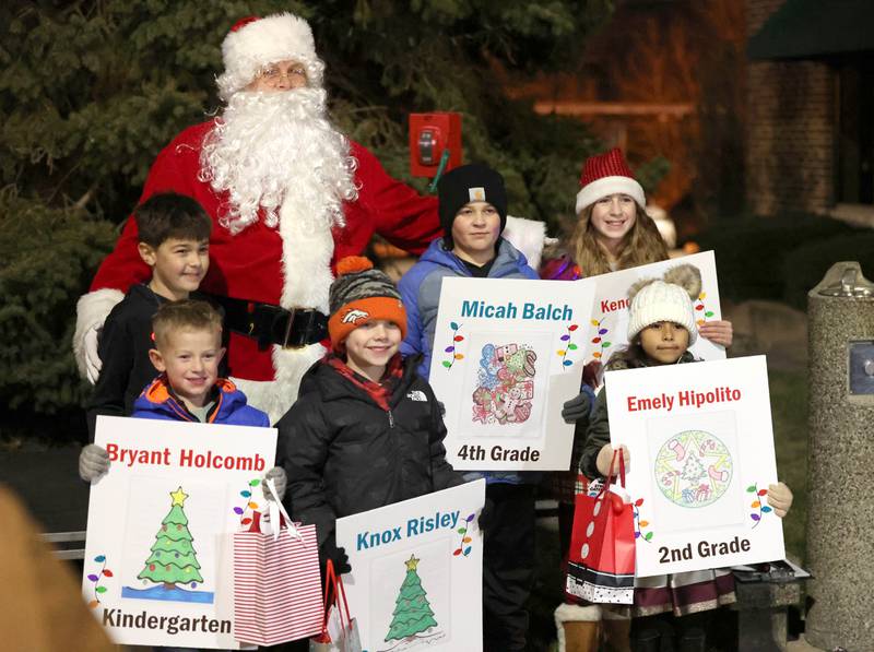 Coloring contest winners pose with Santa Friday, Dec. 2, 2022, during Celebrate the Season hosted by the Genoa Area Chamber of Commerce.