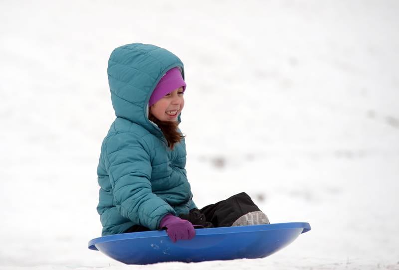 Juliana Rodriguez of Brookfield enjoys sledding at Memorial Park in Lagrange Park Saturday, Jan 13, 2024.