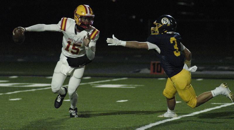 Rock Island QB  Jae'vion Clark-pugh   slips an outstreatched arrn of Cobey Shipma  of Sterling.   Action took place on Friday, October  18th, 2024 in Sterling.