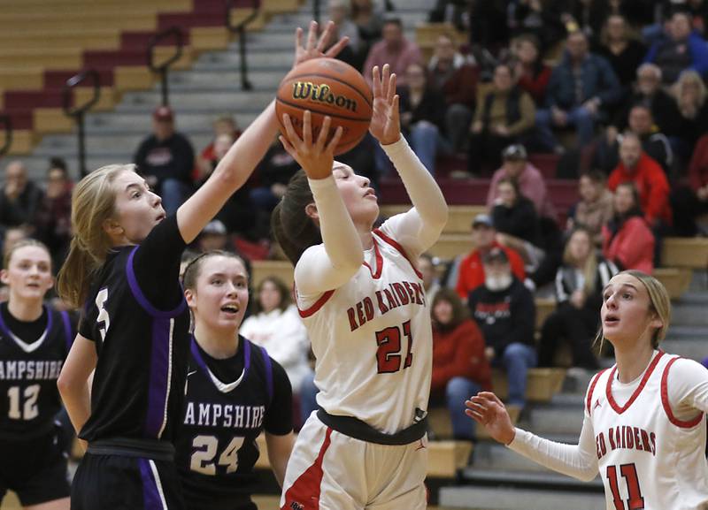 Huntley's Samantha Campanelli drives to tree basket in front of Hampshire's Avery Cartee and Whitney Thompson during a Fox Valley Conference girls basketball game Monday, Jan. 30, 2023, at Huntley High School.