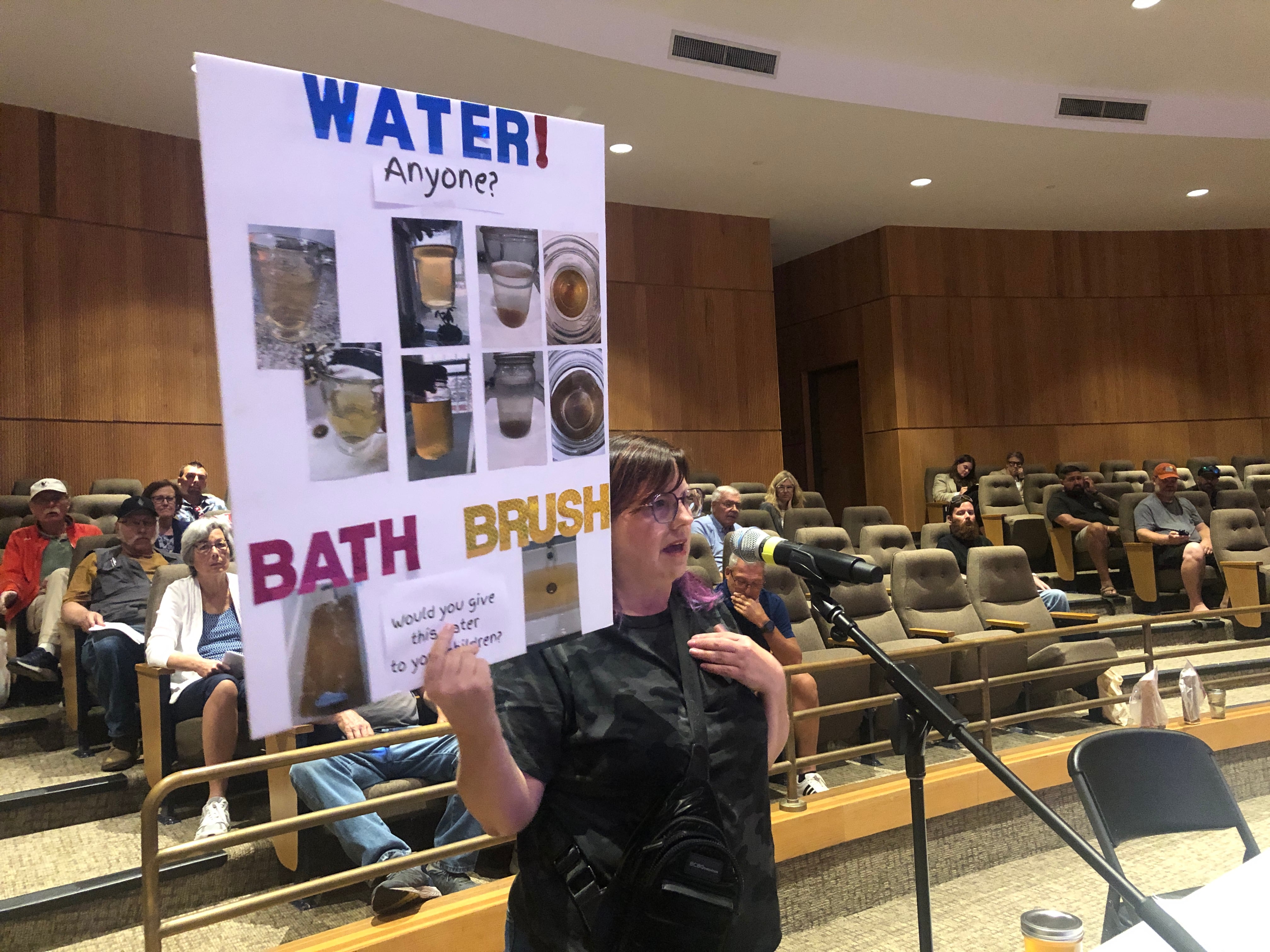 An Aqua Illinois customer brought photos of her water to a hearing held Monday, July 29, 2024, at McHenry County College. The private water utility company is asking the Illinois Commerce Commission to approve a rate hike customers say will add $30 a month to their water bills.