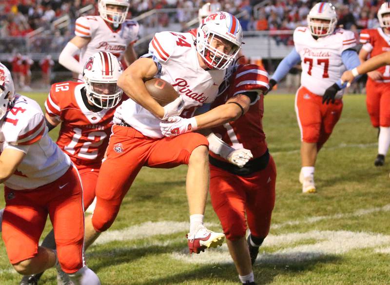 Ottawa's Weston Averkamp gets a few extra yards while being brought down by Streator's Kameron Magana on Friday, Sept. 6, 2024 at Doug Dieken Stadium.