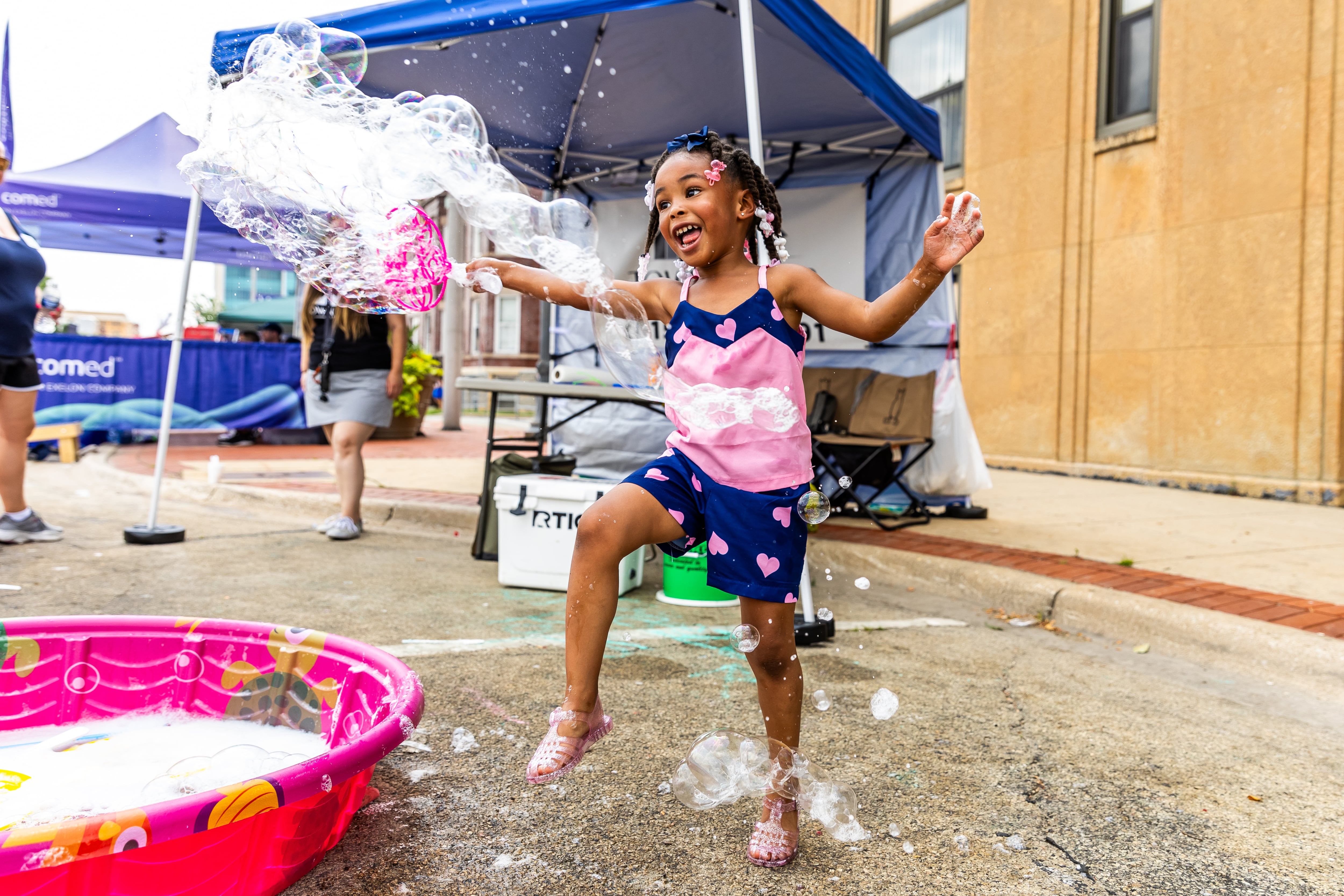 Joliet resident Reagan Craig (4) has fun with bubbles during Kidz Fest in Joliet on Aug. 3, 2024.