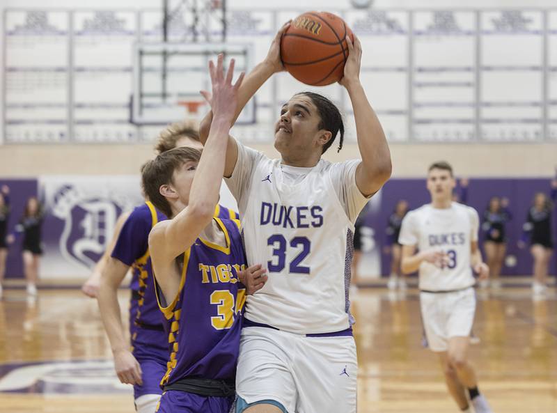 Dixon’s Darius Harrington puts up a shot over Sherrard’s Rylan Carton Thursday, Feb. 15, 2024 at Dixon High School. The shot was Harrington’s 1,000 point of his career.