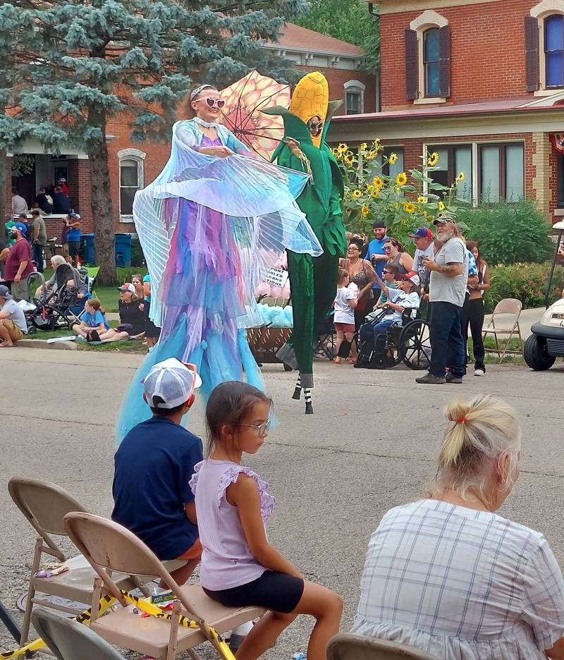 Stilt walkers make their way through the Mendota Sweet Corn Festival parade Sunday, Aug. 13, 2023.