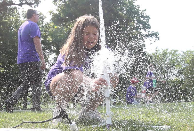 Bailey Knowles launches a two-liter rocket bottle during the 22na annual Carus Summer Science Camp on Friday, July 12, 2024 at St. Bede Academy.