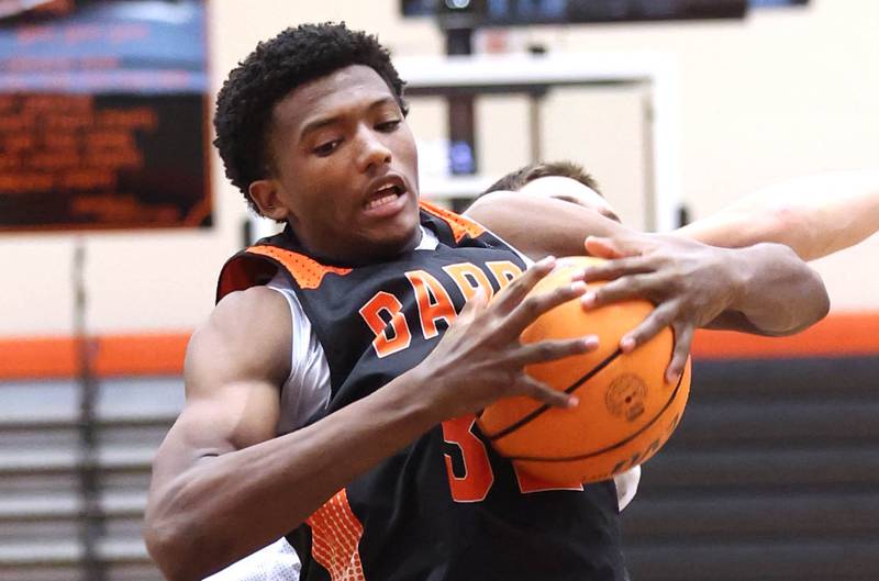 DeKalb’s Justin O'Neal pulls down a rebound during their summer game against Elk Grove Tuesday, June 18, 2024, at DeKalb High School.