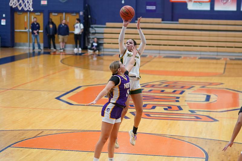 Waubonsie Valley's Danyella Mporokoso (10) shoots the ball in the post over Downers Grove North's Abby Gross (11) during a Oswego semifinal sectional 4A basketball game at Oswego High School on Tuesday, Feb 20, 2024.